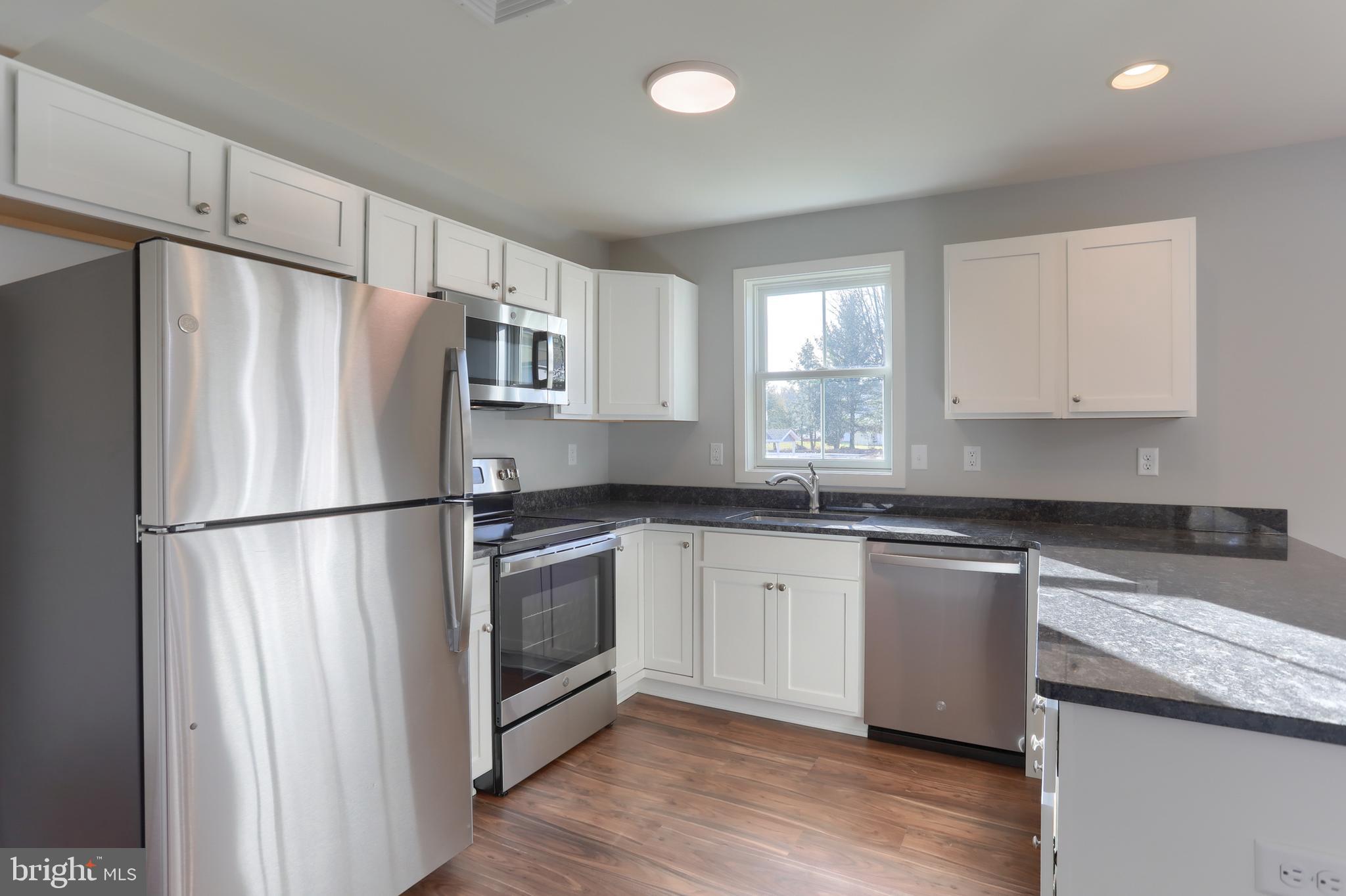 176 Lamp Post Lane Hershey, PA 17033 - Photo 15 of 33 a kitchen with stainless steel appliances granite countertop a refrigerator sink and microwave