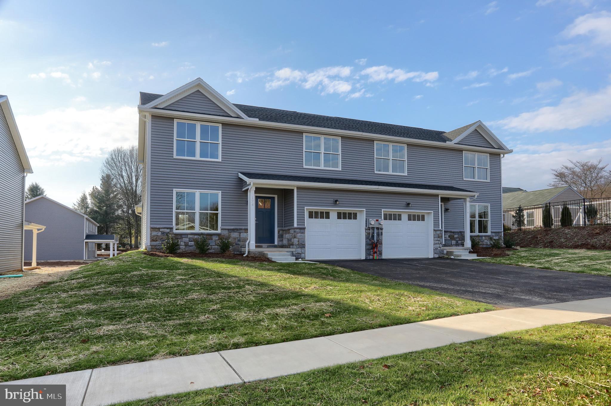 176 Lamp Post Lane Hershey, PA 17033 - Photo 3 of 33 a view of a yard in front of a brick house with a large windows