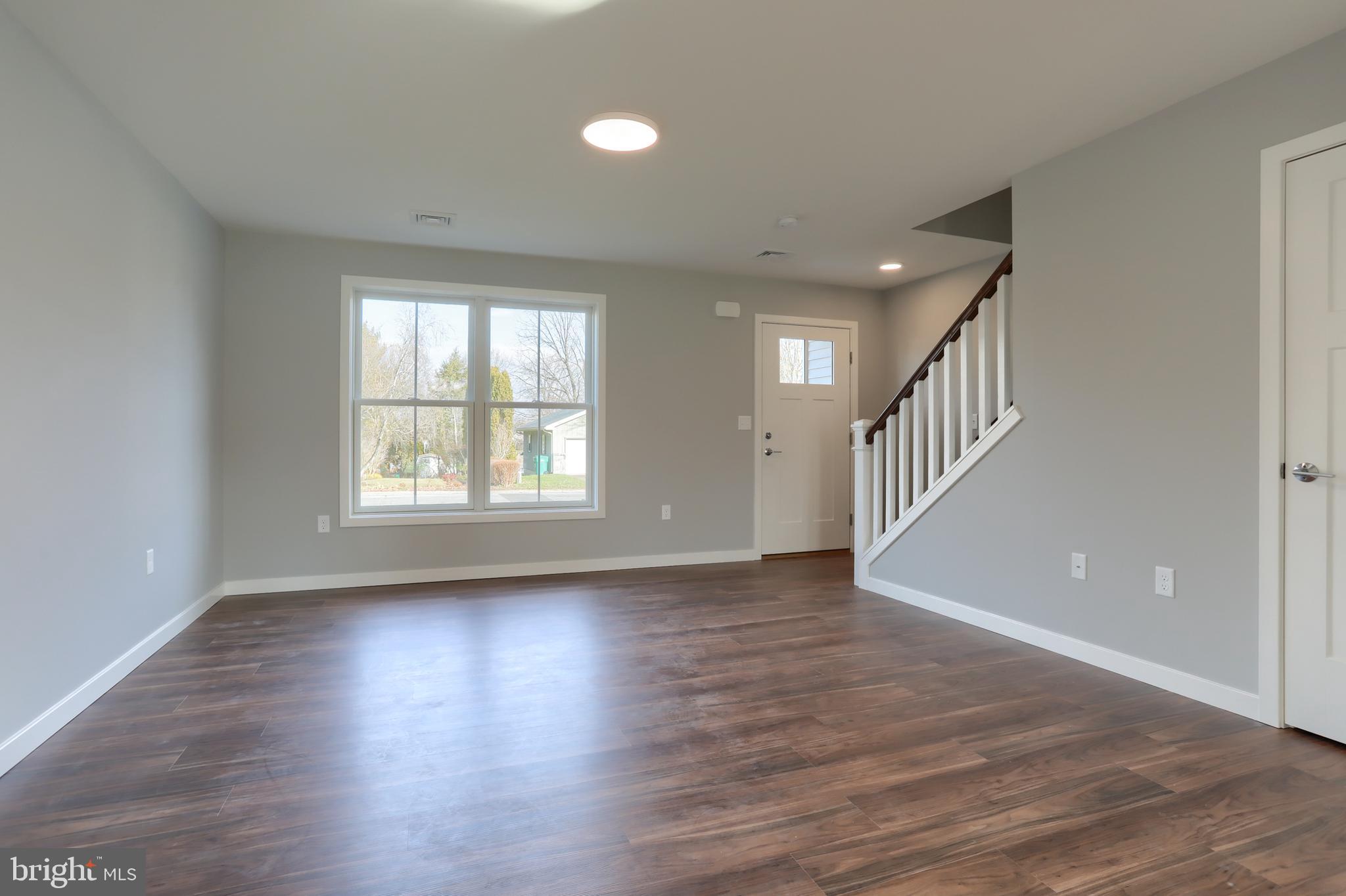176 Lamp Post Lane Hershey, PA 17033 - Photo 5 of 33 a view of an empty room with wooden floor and a window