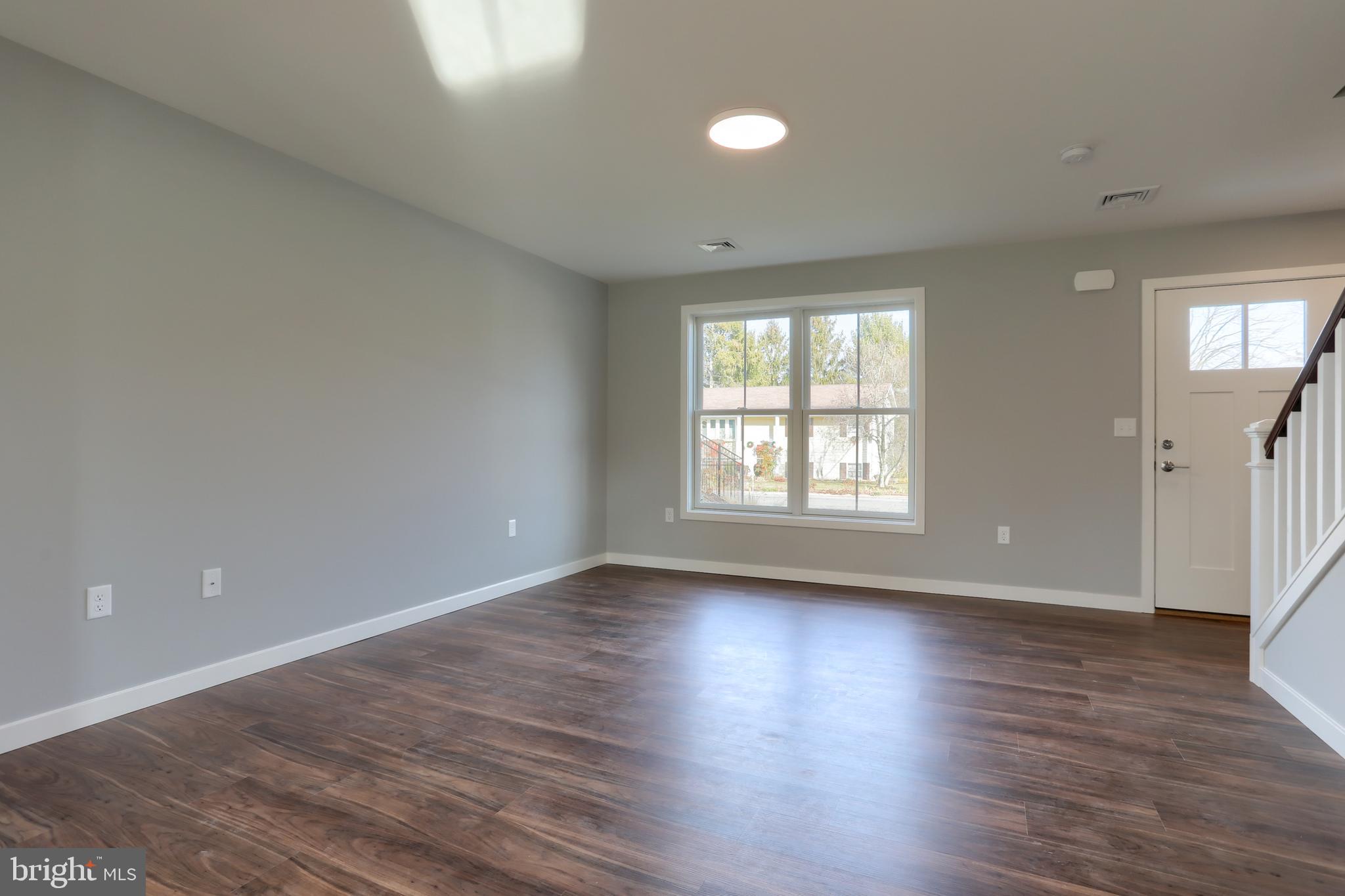 176 Lamp Post Lane Hershey, PA 17033 - Photo 6 of 33 a view of an empty room with wooden floor and a window