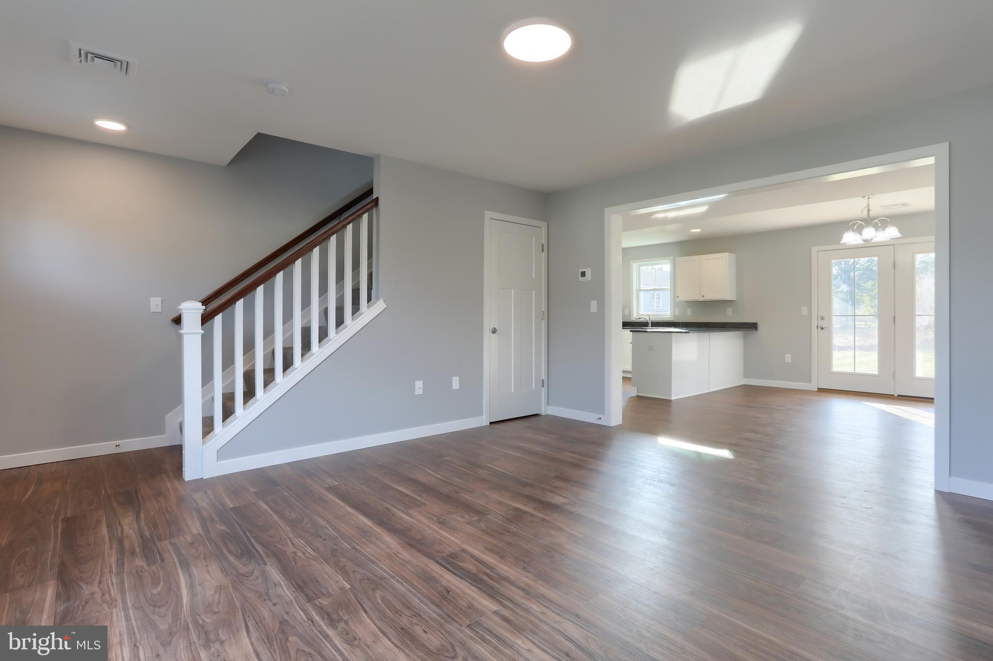 176 Lamp Post Lane Hershey, PA 17033 - Photo 8 of 33 a view of a hallway with wooden floor and a kitchen
