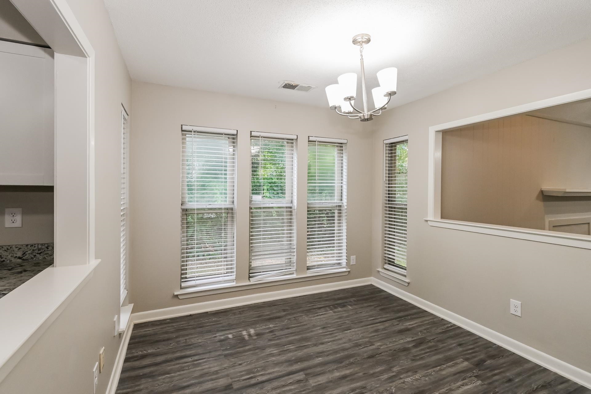 2572 Lynnfield Road Memphis, TN 38119 - Photo 7 of 21 Unfurnished room with an inviting chandelier and dark hardwood / wood-style flooring