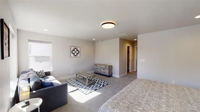 a bedroom with a bed and a lamp