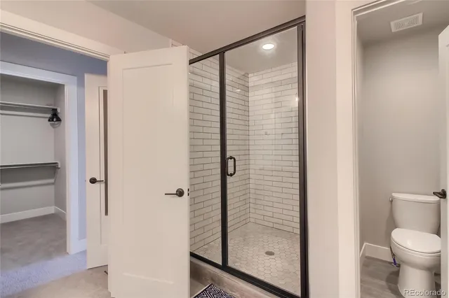 a bedroom with a bed and cabinets