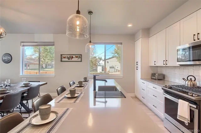 a kitchen with granite countertop a sink and a stove top oven