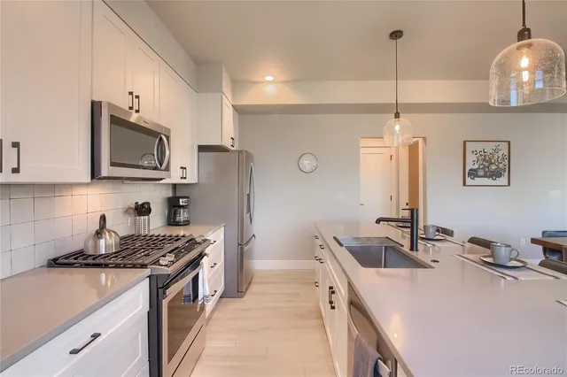 a bathroom with a granite countertop toilet sink and mirror