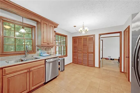 a large kitchen with a large window and refrigerator