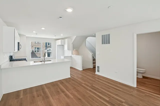 a view of kitchen with cabinets and wooden floor