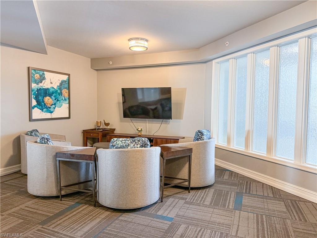 1100 Pine Ridge Road, Unit 201B Naples, FL 34108 - Photo 3 of 18 a view of a living room and a flat screen tv