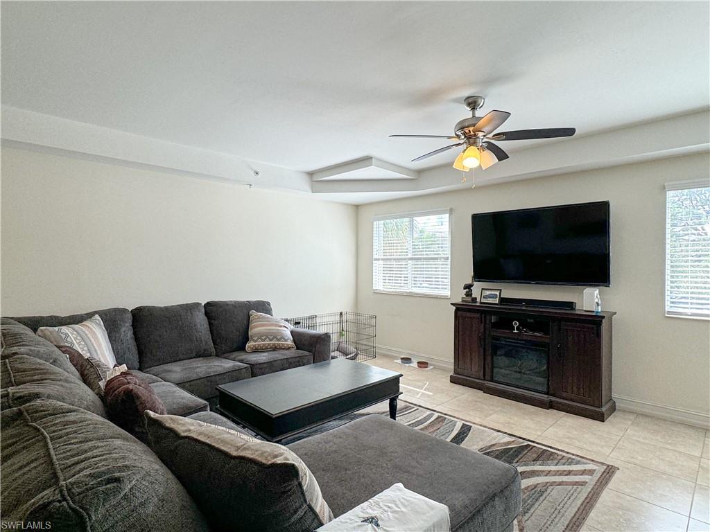 1100 Pine Ridge Road, Unit 201B Naples, FL 34108 - Photo 5 of 18 a living room with furniture and a flat screen tv
