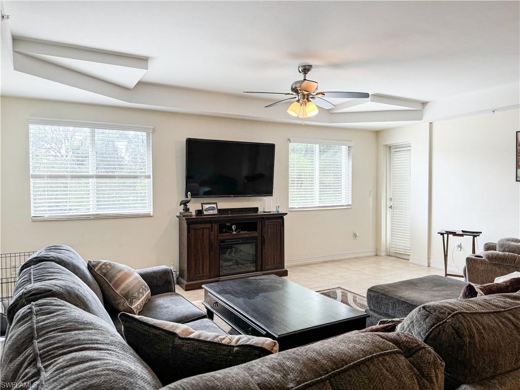 1100 Pine Ridge Road, Unit 201B Naples, FL 34108 - Photo 9 of 18 a living room with furniture and a flat screen tv