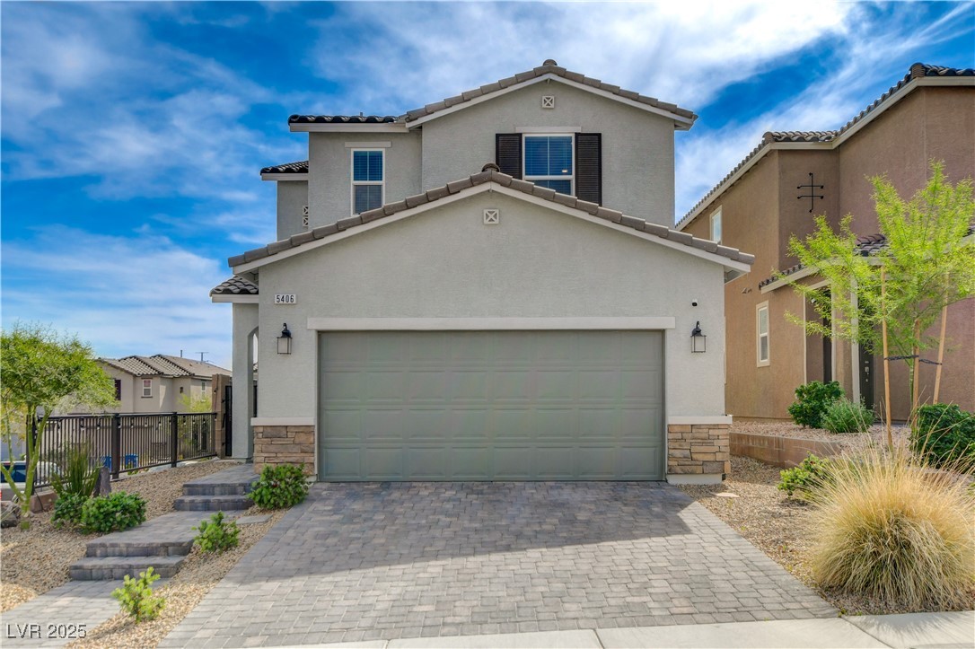 Traditional-style house with a tile roof, stone si