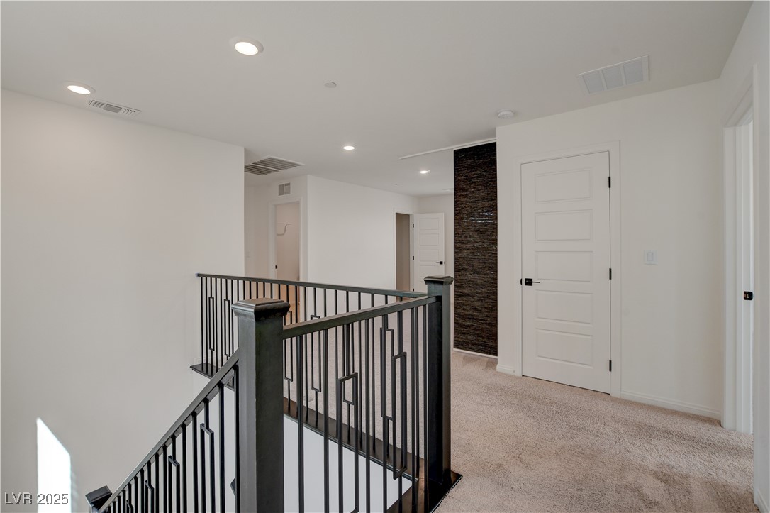 5406 Zacatin Court Las Vegas, NV 89166 - Photo 11 of 23 Hallway featuring carpet, visible vents, and an up