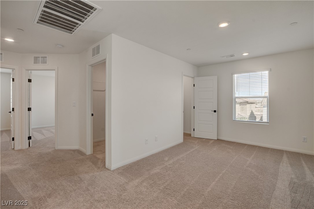 5406 Zacatin Court Las Vegas, NV 89166 - Photo 15 of 23 Spare room with light carpet and visible vents