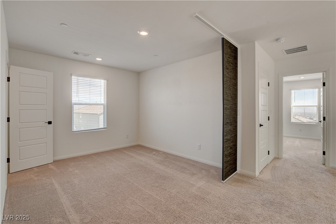 5406 Zacatin Court Las Vegas, NV 89166 - Photo 16 of 23 Empty room with baseboards, visible vents, and lig