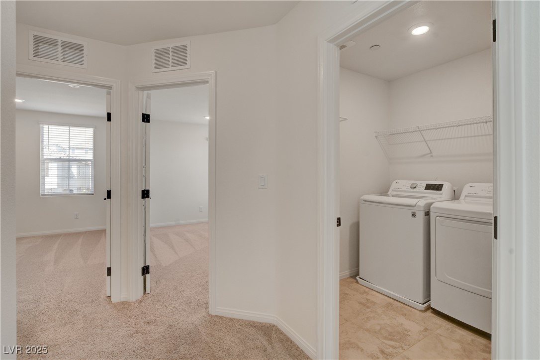 5406 Zacatin Court Las Vegas, NV 89166 - Photo 17 of 23 Laundry room with light colored carpet, laundry ar