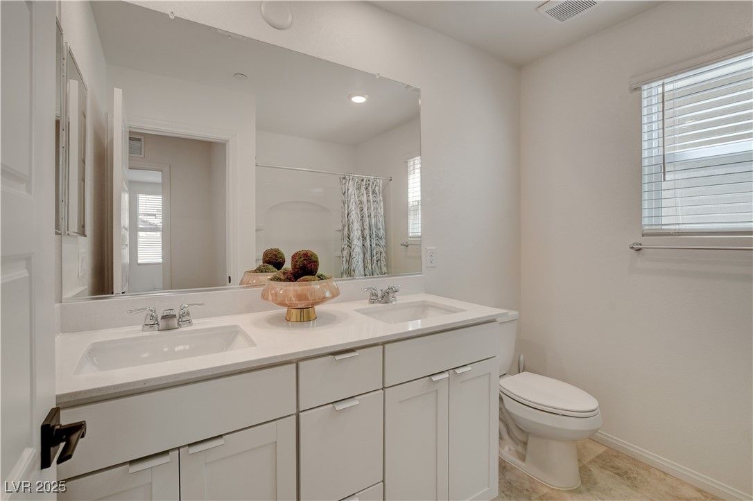 5406 Zacatin Court Las Vegas, NV 89166 - Photo 18 of 23 Full bathroom with toilet, a sink, visible vents,