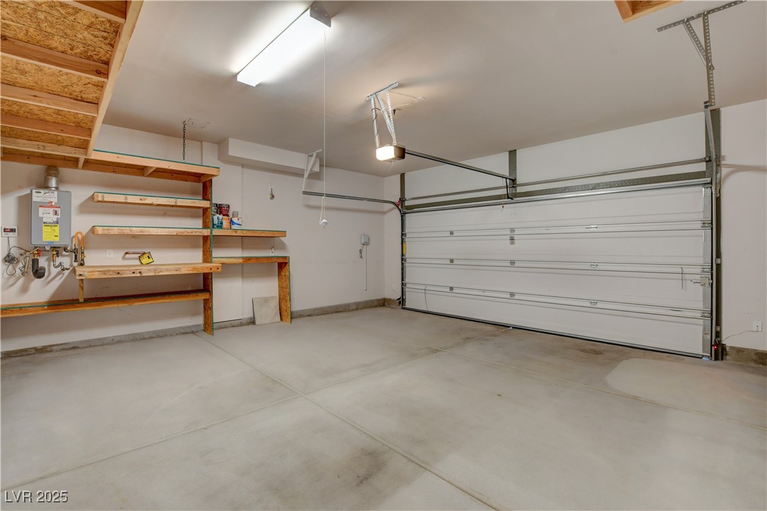 5406 Zacatin Court Las Vegas, NV 89166 - Photo 19 of 23 Garage featuring a garage door opener and tankless