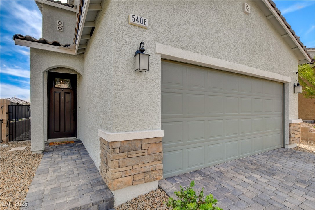 5406 Zacatin Court Las Vegas, NV 89166 - Photo 2 of 23 View of exterior entry featuring a gate, a tiled r