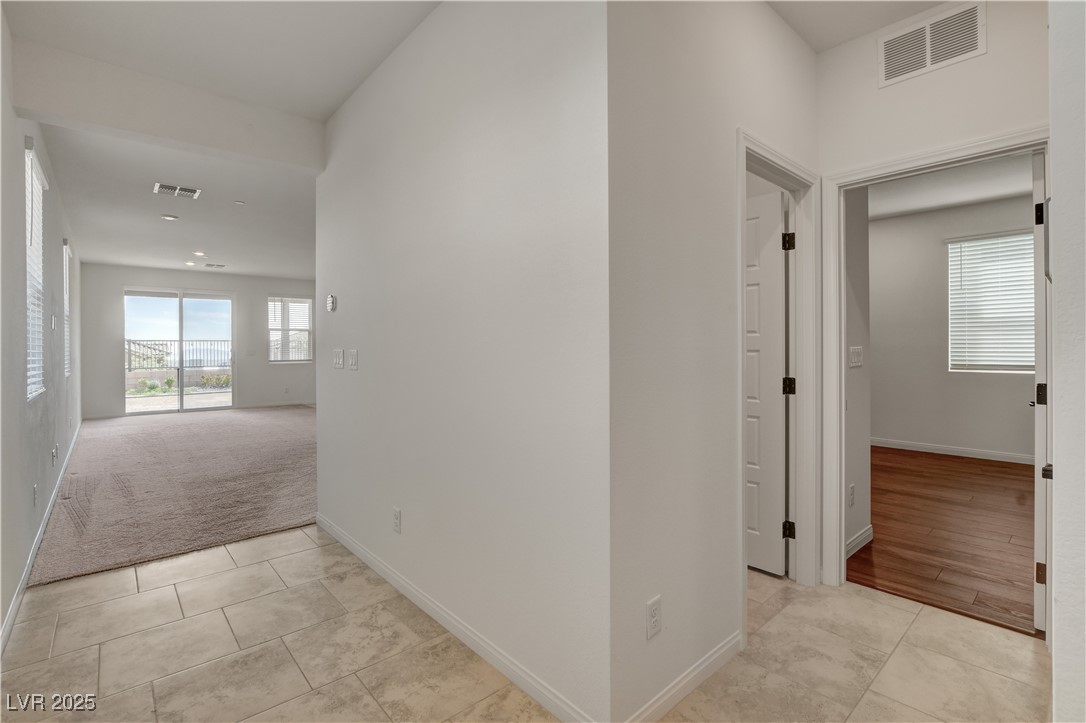 5406 Zacatin Court Las Vegas, NV 89166 - Photo 3 of 23 Hallway with baseboards, light tile patterned floo