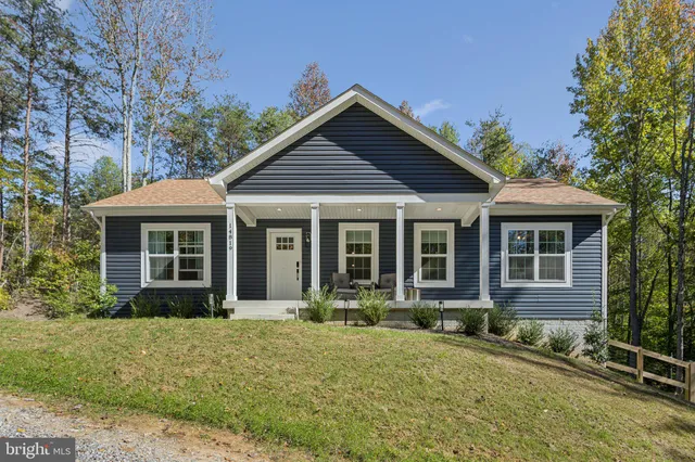 a front view of house with yard outdoor seating and barbeque oven