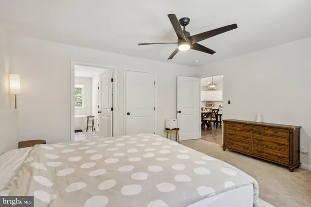 a bedroom with a large bed and a ceiling fan