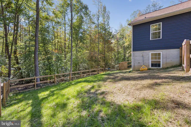 a view of a backyard with large trees