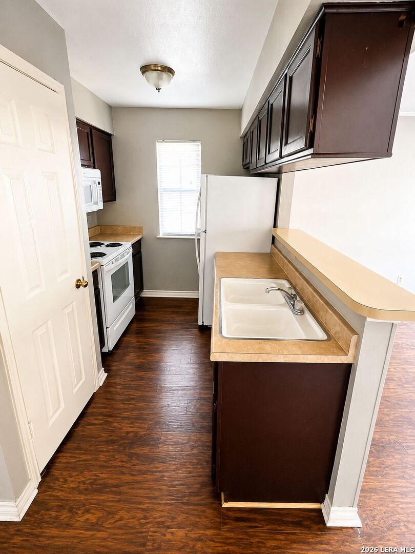 11610 Vance Jackson Road, Unit 867 San Antonio, TX 78230 - Photo 7 of 10 a view of kitchen with sink microwave and refrigerator