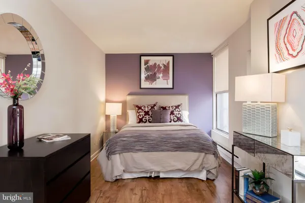 a bedroom with a bed and a potted plant