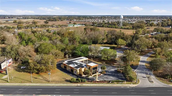 an aerial view of a residential houses with city view