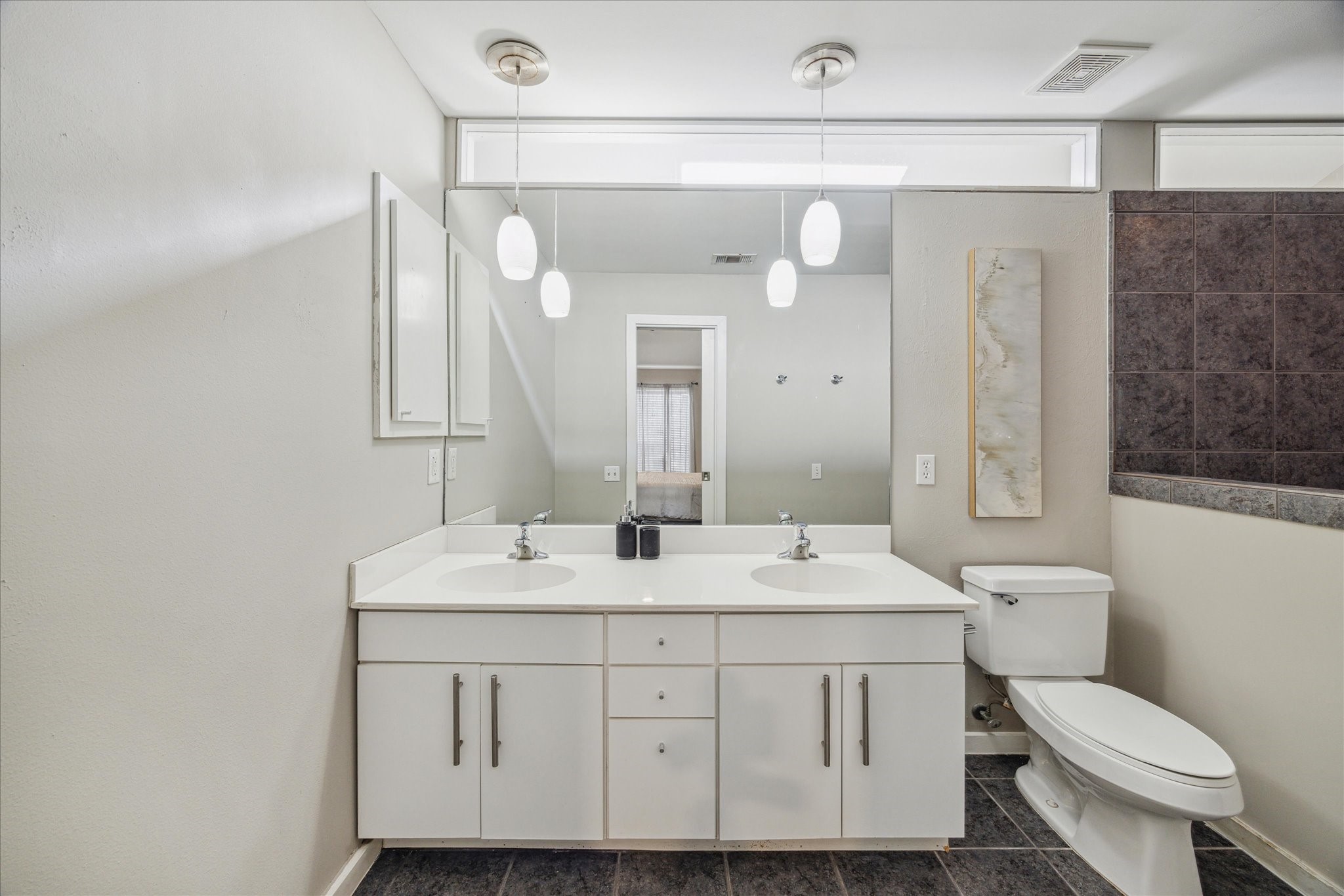 6111 Gehring Street Houston, TX 77021 - Photo 12 of 16 a bathroom with a toilet a sink and a mirror