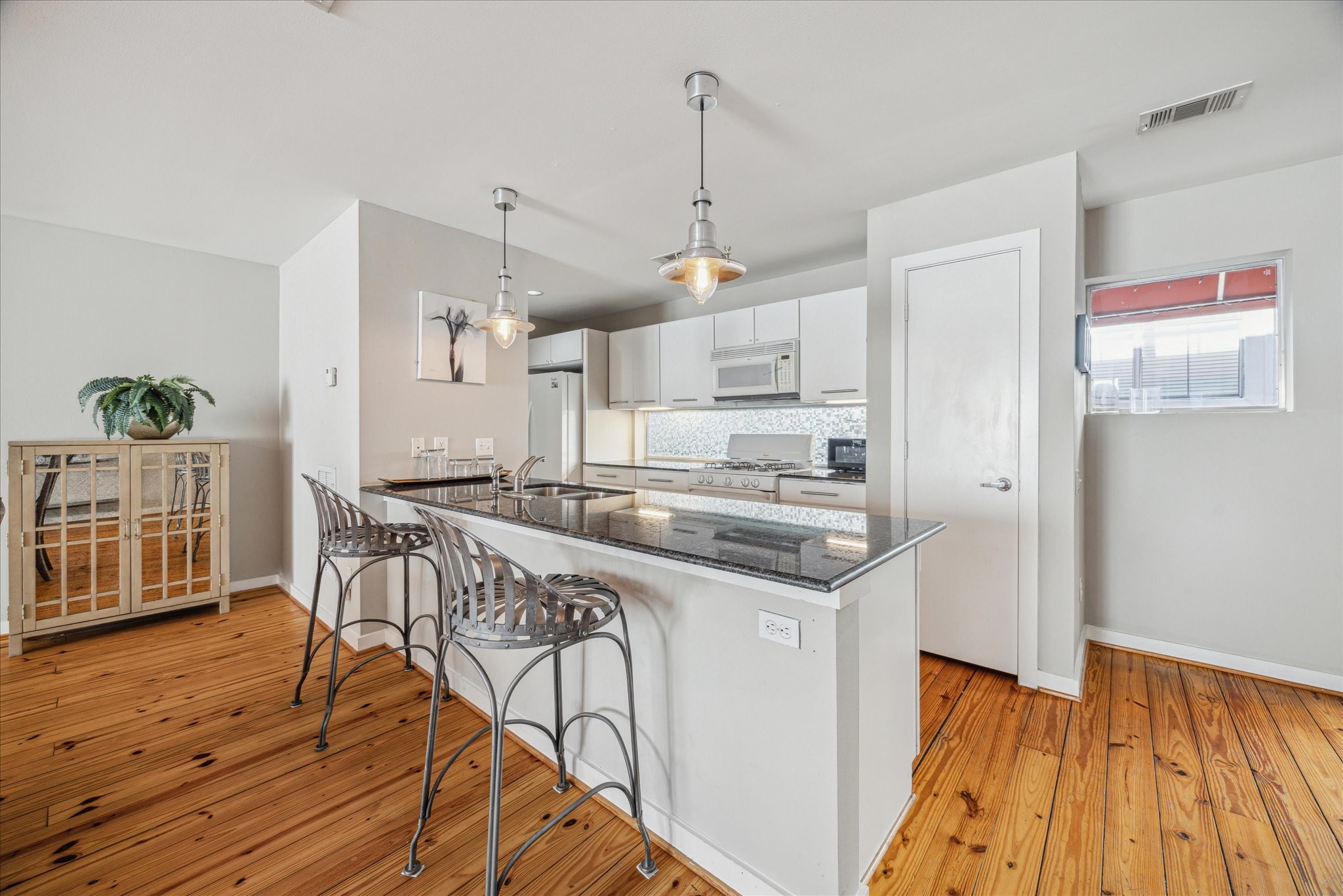 6111 Gehring Street Houston, TX 77021 - Photo 9 of 16 a kitchen with stainless steel appliances granite countertop a kitchen island hardwood floor and a sink