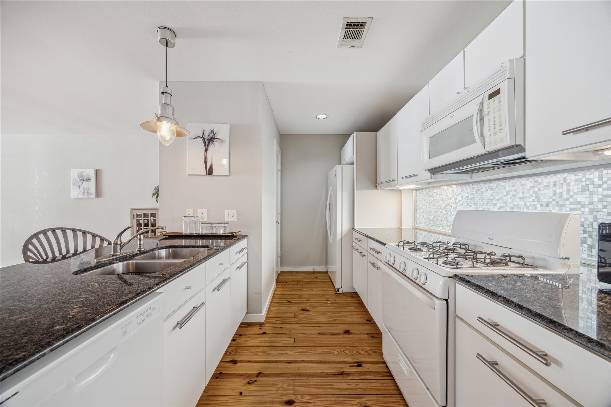 6111 Gehring Street Houston, TX 77021 - Photo 10 of 16 a large kitchen with granite countertop a stove and a sink