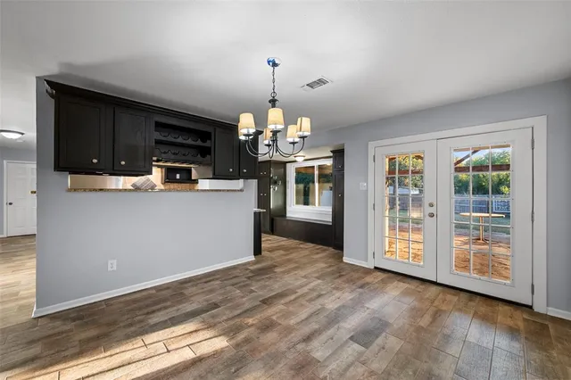 a view of a kitchen with a stove wooden cabinets and a window