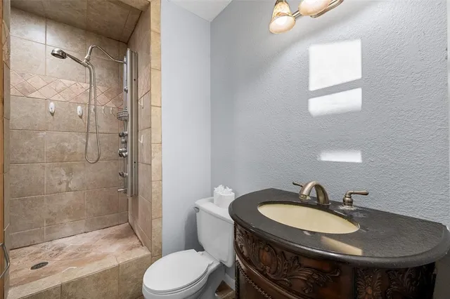 a bathroom with a sink toilet and shower