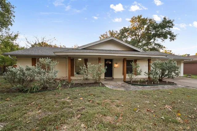a front view of a house with yard patio and porch