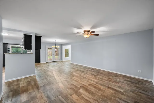 a view of a livingroom with a kitchen counter tops and a wooden floor