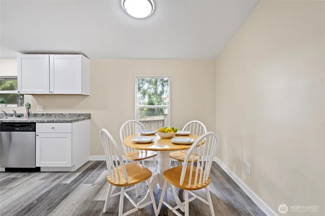 a dining room with furniture and wooden floor