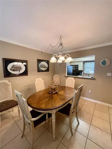 a dining room with furniture and chandelier