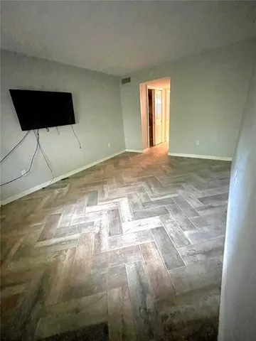a view of empty room with a fireplace