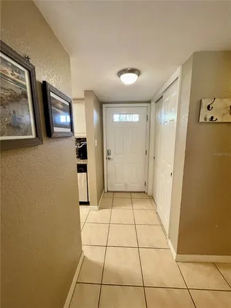 a view of a hallway to rooms and stairs