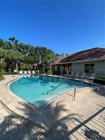 a view of a swimming pool with outdoor seating