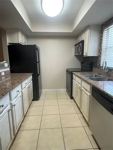 a kitchen with a stove top oven and cabinets