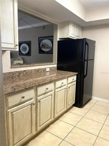 a kitchen with stainless steel appliances granite countertop a refrigerator and a microwave