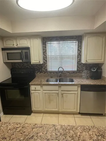a kitchen with stainless steel appliances granite countertop a sink and a granite counter tops