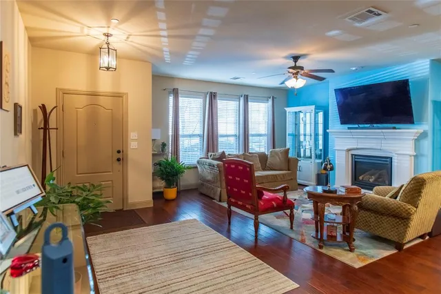 a living room with furniture fireplace and a flat screen tv