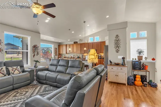 a living room with furniture and kitchen view