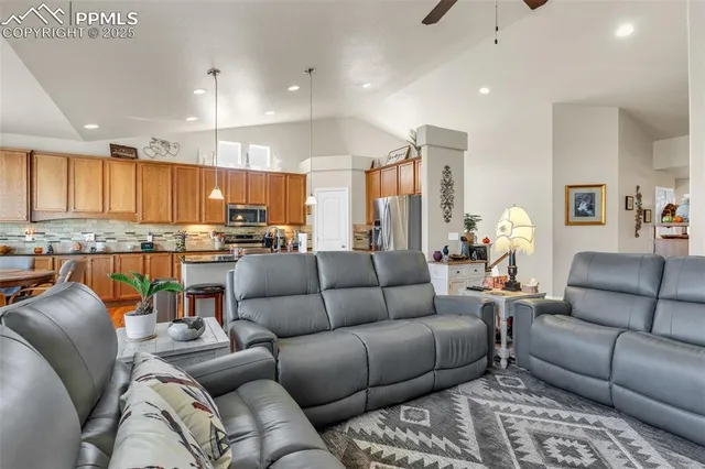 a living room with furniture kitchen and a view of kitchen