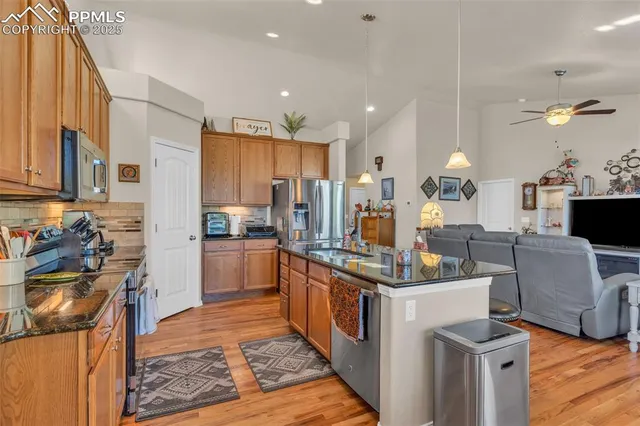 a kitchen with kitchen island stainless steel appliances a stove a sink and a refrigerator