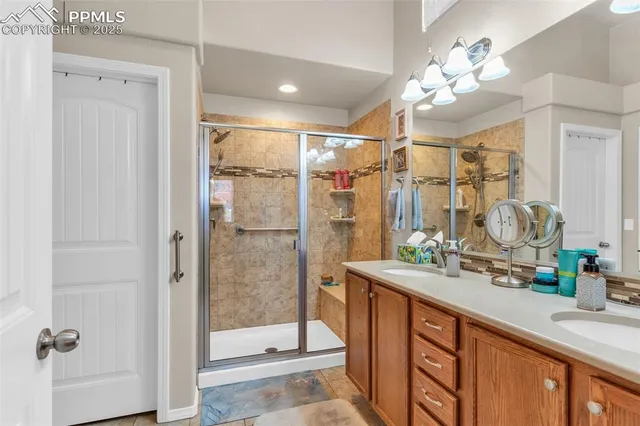 a bathroom with a double vanity sink mirror and shower